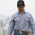 A person with ginger hair and beard, wearing a black embroidered ACC Embroidered Hat by Rural Cloth featuring the text 