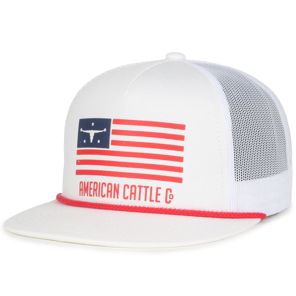 The ACC Flag Hat by Rural Cloth is a stylish white baseball cap with a breathable mesh snapback. It features a red, white, and blue American flag design with a steer head icon and the words 