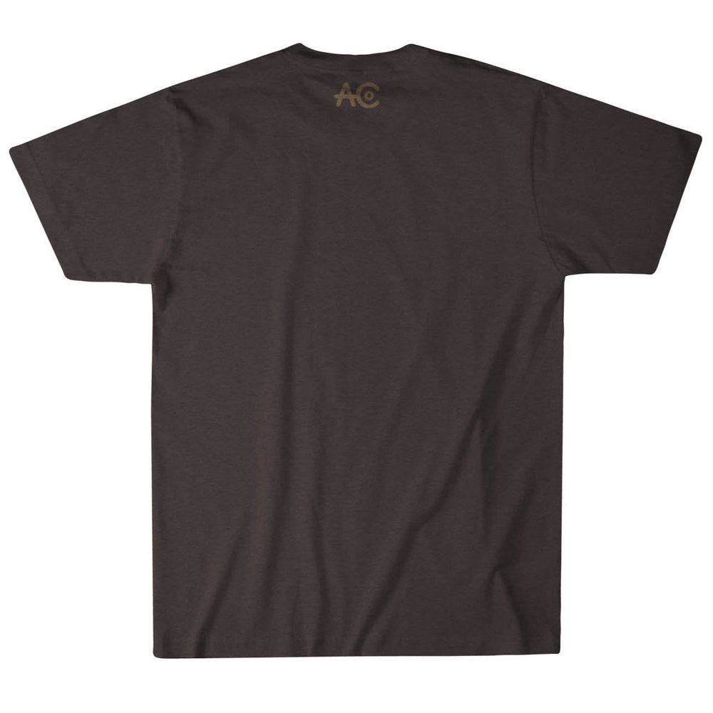The Rural Cloth ACC Longhorn Tee is displayed from the back in dark gray, with a small brown "AC" logo at the top center, representing American Cattle Co. This short-sleeve shirt boasts a simple, casual design that reflects an American heritage lifestyle.