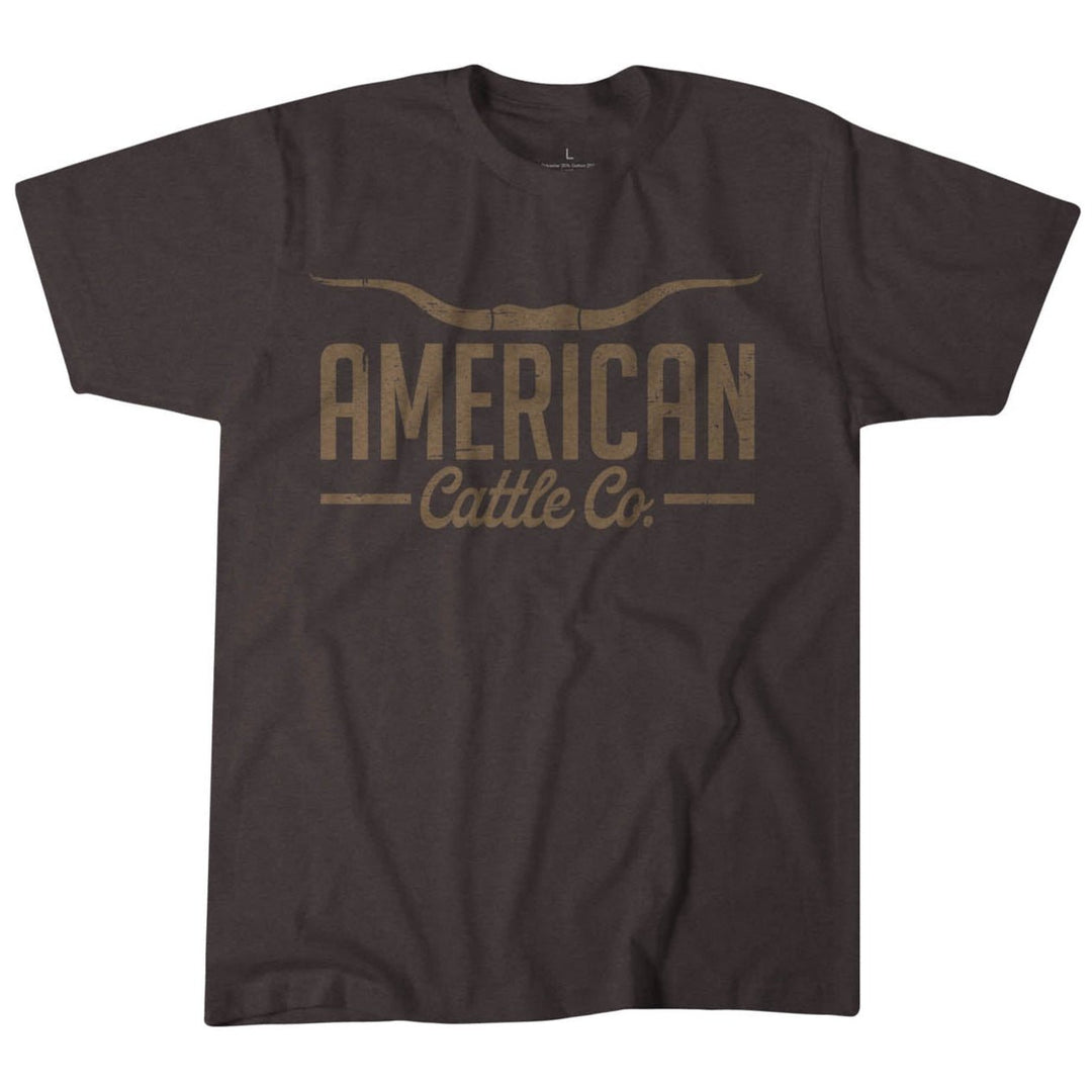 The ACC Longhorn Tee by Rural Cloth is a dark gray shirt featuring "AMERICAN Cattle Co." in a rustic font with cattle horns above "American," celebrating American heritage and the authentic cattle lifestyle.