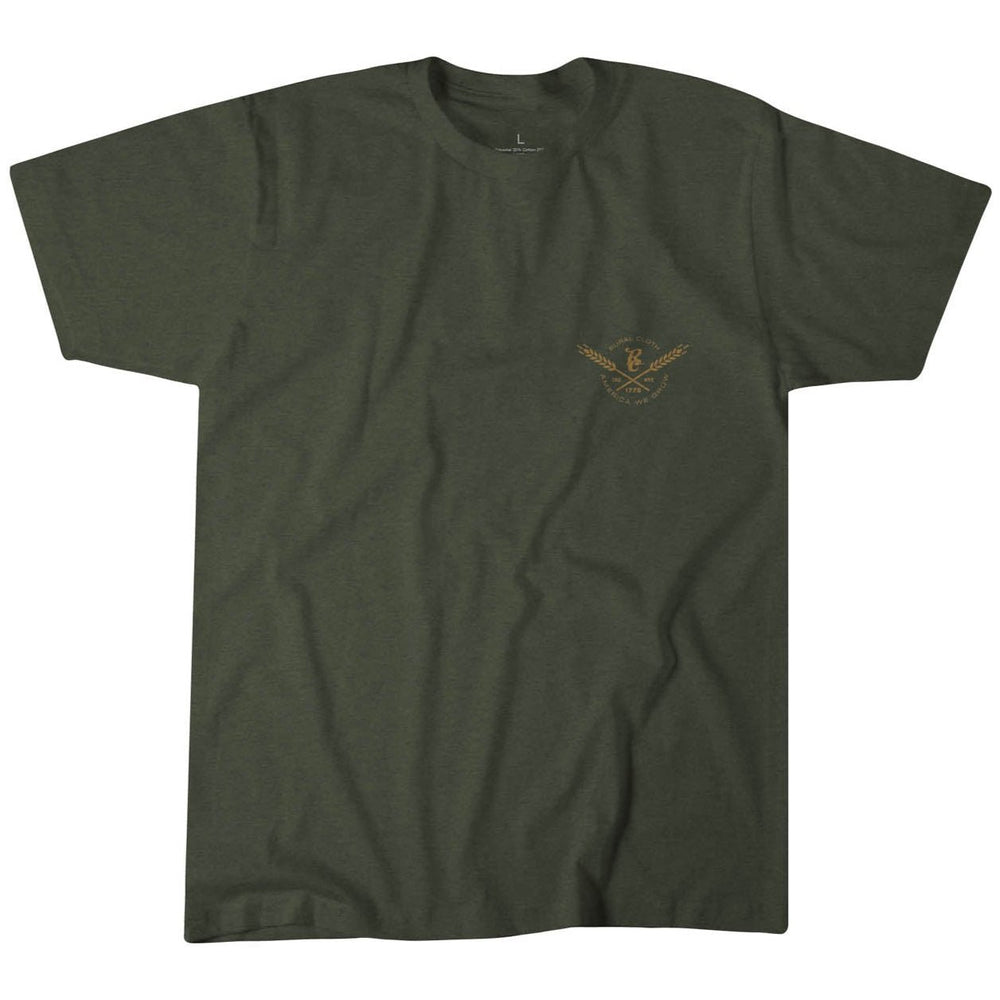 The "America We Hunt Turkey Tee" by Rural Cloth is a dark green T-shirt made from premium weight fabric. It features a small gold graphic of crossed rifles and a bird emblem on the front left side, offering a modern fit. Displayed against a plain white background.