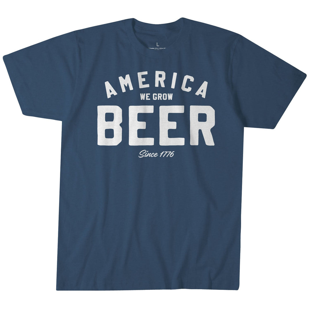 The Rural Cloth Beer Tee is a blue shirt crafted from super soft cotton, featuring bold white text that reads "AMERICA WE GROW BEER Since 1776," with "BEER" prominently centered as the largest word. This tee celebrates America's brewing tradition.