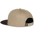 The Billboard Script Hat by 253408 is a tan cap with a black brim, shown from the back. It exudes a ranching vibe and includes an adjustable snapback strap, small embroidered logo near the opening, smooth fabric, and sturdy construction.