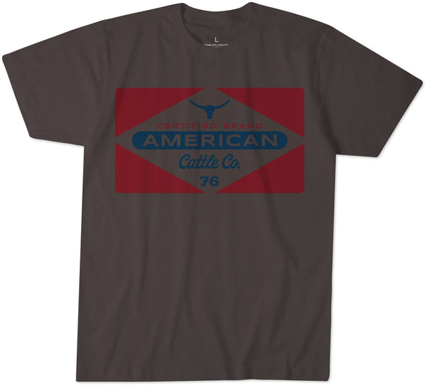 The Billboard Tee by Rural Cloth is a dark gray T-shirt made from super soft combed cotton. It features a large graphic on the front that includes a red diamond shape with a blue bull head at the top and the text 