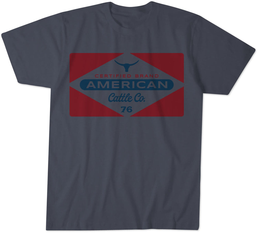 The Rural Cloth Billboard Tee is crafted from super soft combed cotton and features a graphic design showcasing a red diamond shape with a bull silhouette. The text "Certified Brand American Cattle Co. 76" is emblazoned in blue and white.