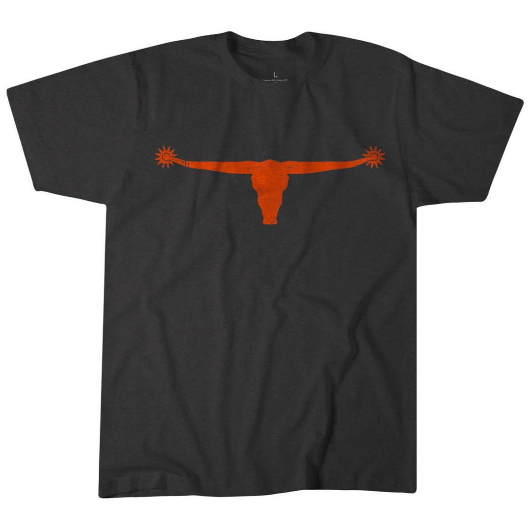 The Bull Spurs Icon Tee by Rural Cloth is a dark gray shirt featuring a vibrant orange longhorn emblem with extended horns, centered on the chest, capturing the essence of rural American spirit.