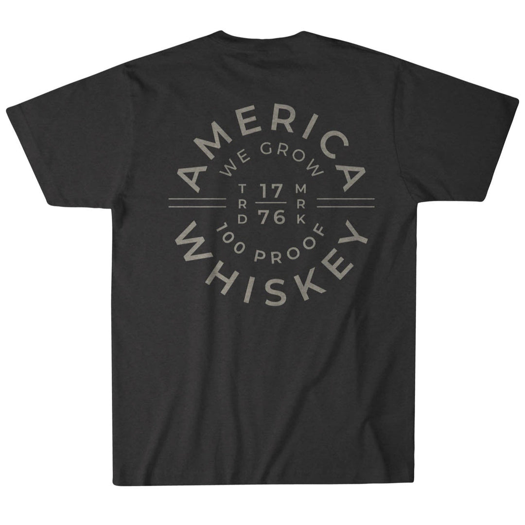 The Cope Tee from Rural Cloth is crafted from premium weight fabric, featuring a striking back design with circular text: "America Whiskey, We Grow, 1776, 100 Proof," offering an authentic retro style with typographic flair.