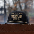 A black mesh snapback, known as the Longhorn Hat from Rural Cloth, featuring the words 