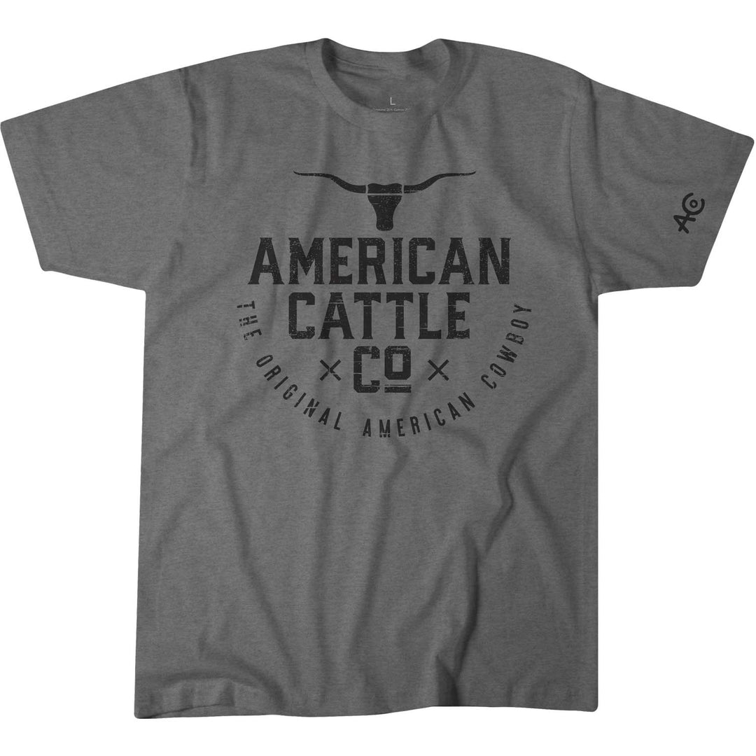 The Ride 'Em Cowboy Tee by Rural Cloth features a striking front longhorn print above "American Cattle Co" in black, declaring "The Original American Cowboy." An "AC" logo adds an authentic touch on the left sleeve.