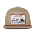 The Rural Cloth Roper Hat is a tan baseball cap with a Western style, featuring a large rectangular patch of a cowboy roping cattle among cacti, labeled 