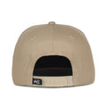 The Roper Hat by Rural Cloth, a beige snapback cap with a modern Western twist, is shown from the back. It features a snap button adjustable strap and a small black tag with 