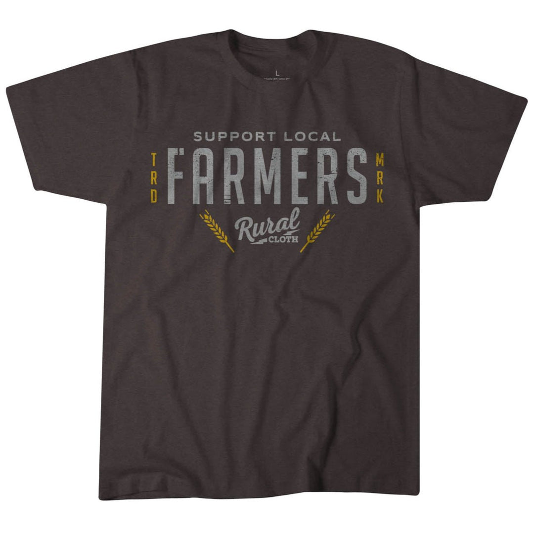 The Support Local Farmers Tee by Rural Cloth is a dark gray t-shirt made from premium weight fabric. It features "Support Local Farmers" in bold white lettering and "Rural Cloth" below in cursive, flanked by yellow accents, offering a contemporary fit with timeless appeal.