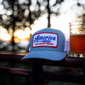 A We Grow Beer Hat-Gray from Rural Cloth, adorned with a white and red patch that reads 