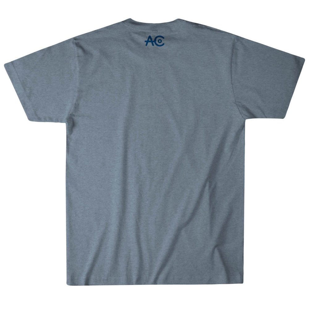 Back view of Rural Cloth's We Ranch You Eat V2 Tee in Blue Heather, showcasing a navy "AC" logo near the neckline. This contemporary fit tee offers short sleeves and is crafted for comfort and durability from premium weight fabric.