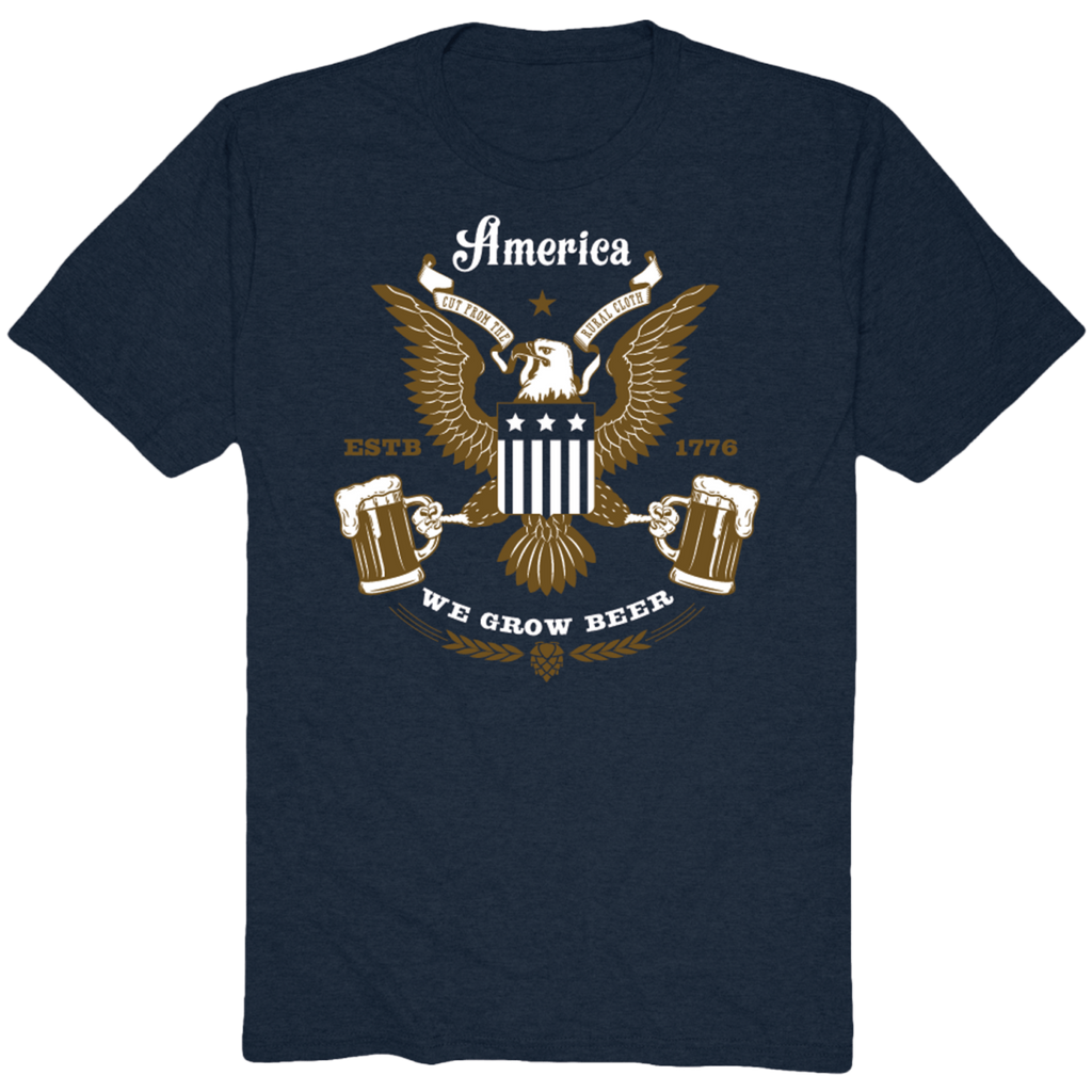 The America Beer Eagle Tee by Rural Cloth is a navy blue t-shirt that boasts a graphic design of a bald eagle with a shield, flanked by two beer mugs. Emblazoned with 