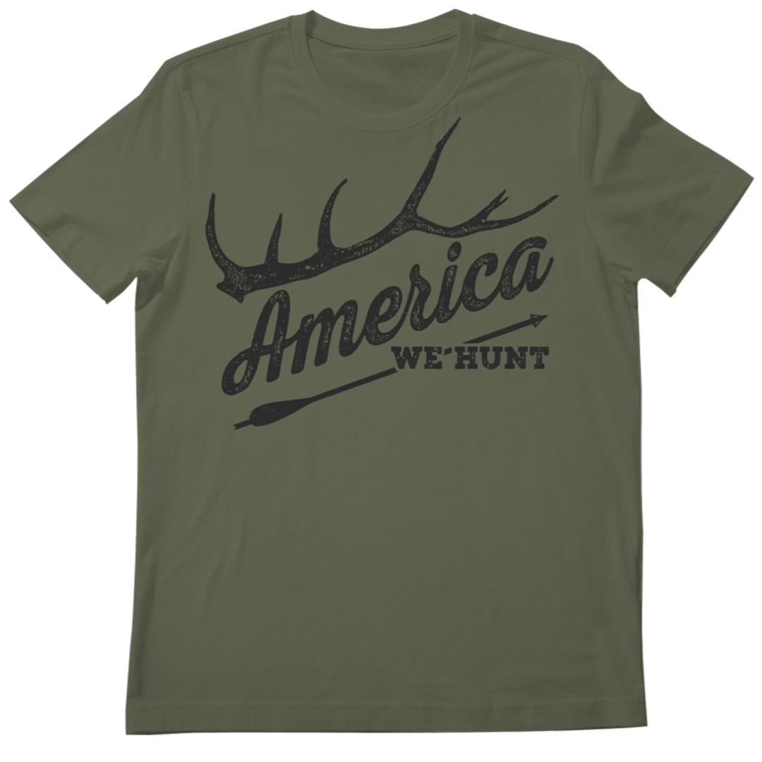 The America We Hunt Tee by Rural Cloth is perfect for outdoor enthusiasts. This green t-shirt features a striking black graphic of an antler and an arrow with "AMERICA" in large letters and "WE HUNT" below, celebrating hunting traditions.