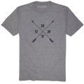 The Hunt Tee by Rural Cloth in heather gray showcases a unique design with two black arrows crossed in the center. The letters U, H, T, and N are strategically positioned between the arrows. Additionally, the word 