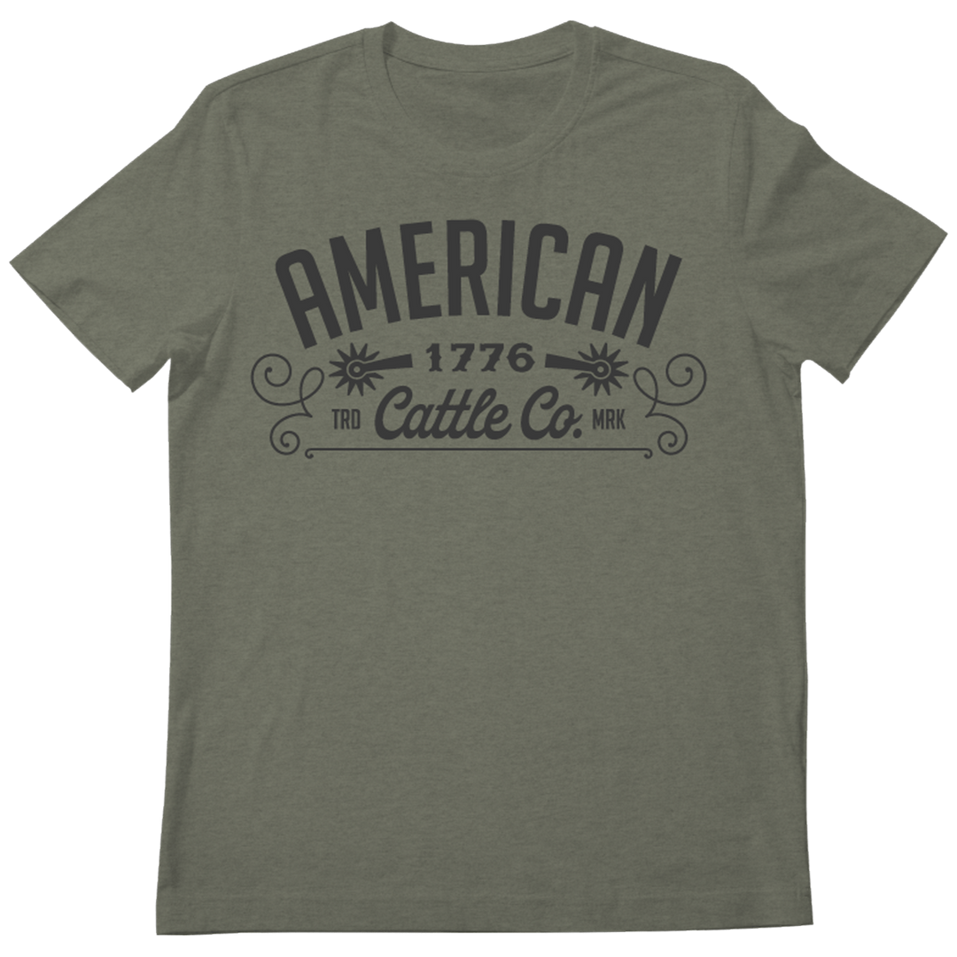 The Western Tee by Rural Cloth is a comfortable and durable gray t-shirt featuring bold, large print text that reads "AMERICAN 1776 Cattle Co. TRD MRK" along with ornamental design elements that capture the spirit of the American cattle industry. This classic shirt includes a crew neck and short sleeves.
